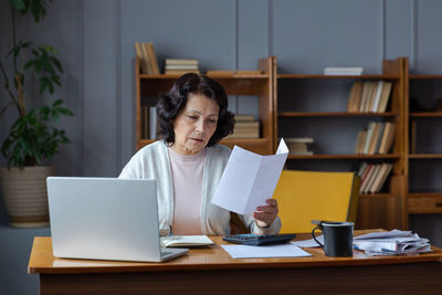 Young woman using laptop at office