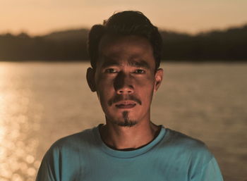 Portrait of man against sky at sunset