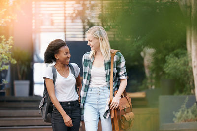 Smiling female friends in campus