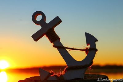 Close-up of fire hydrant against sky during sunset