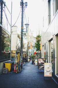 Street amidst buildings in city against clear sky