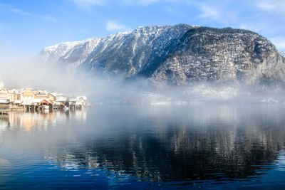 Scenic view of lake against sky during winter