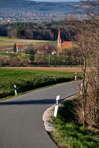 High angle view of road by buildings against sky