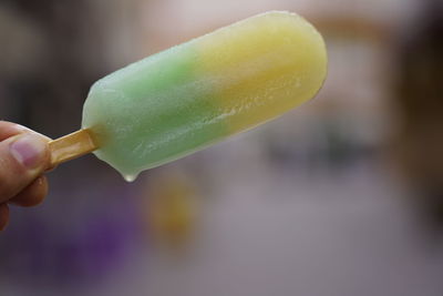 Close-up of hand holding ice cream