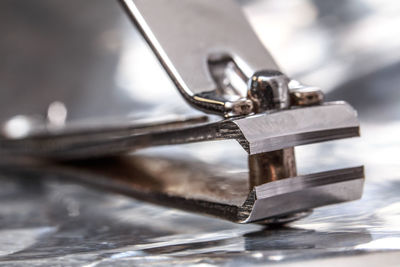 Close-up of nail clipper on table