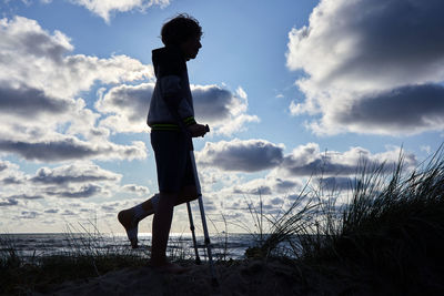 Side view of woman standing on beach