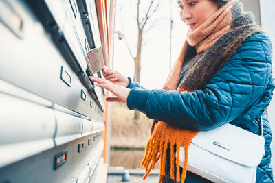 Mature woman checking mailbox