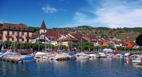 Boats in river with buildings in background