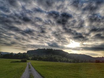 Scenic view of field against sky during sunset
