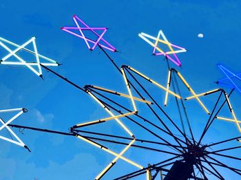 Low angle view of windmill against blue sky