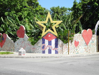 Graffiti on wall by road in city