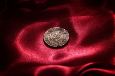 High angle view of coins on metal