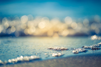 Beautiful small waves on the sea sand at the beach. sunset scenery of a baltic sea beach.
