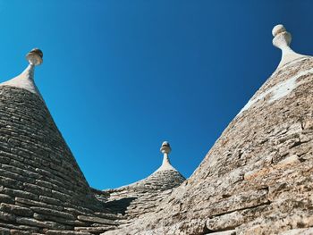 Low angle view of statue against blue sky