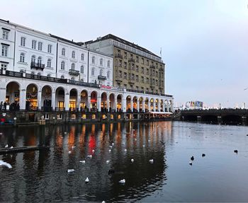 Reflection of building in water against sky