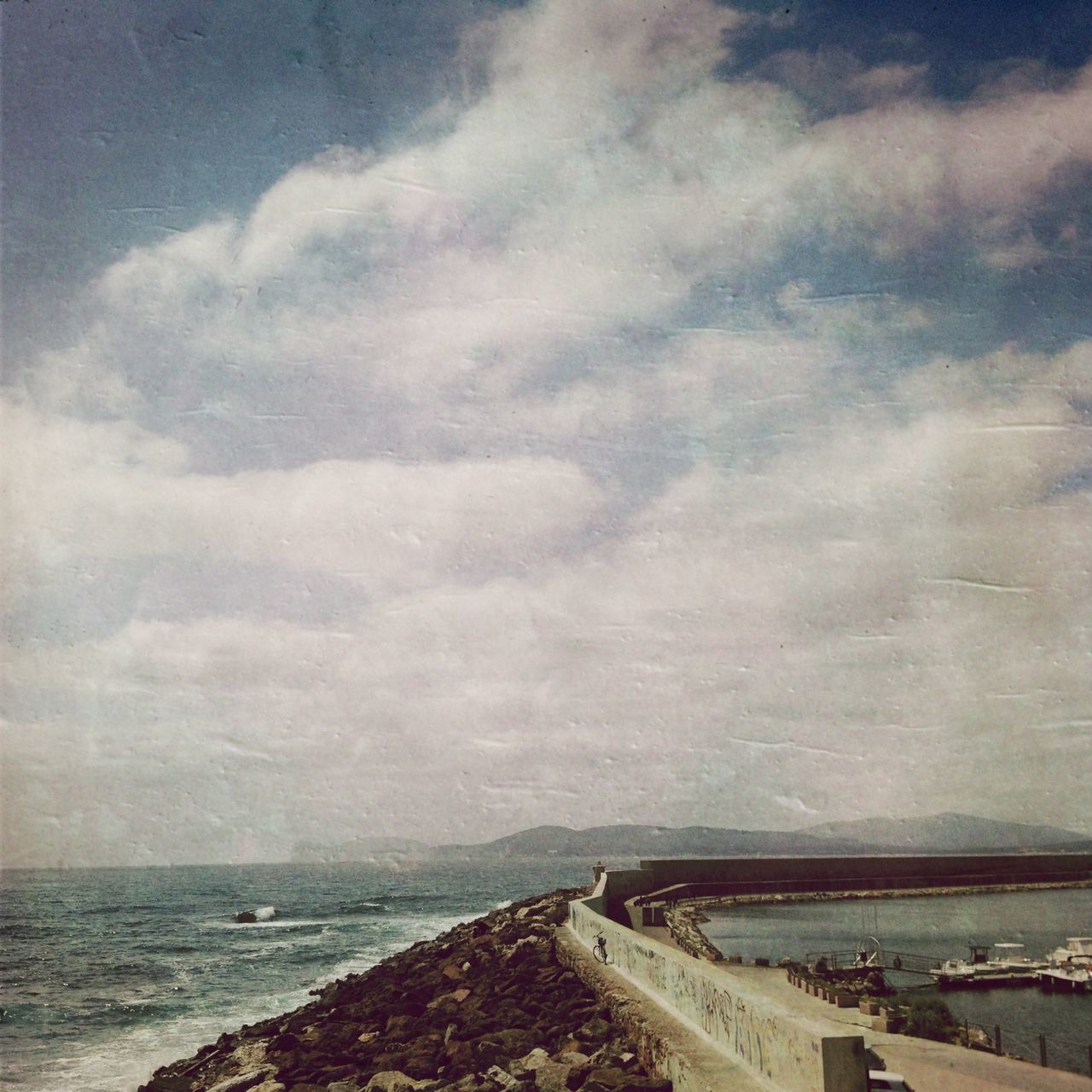 sea, sky, water, cloud - sky, horizon over water, cloudy, scenics, beauty in nature, tranquility, tranquil scene, nature, cloud, weather, overcast, beach, shore, outdoors, rock - object, idyllic, no people