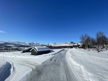 Snow covered mountain against clear blue sky