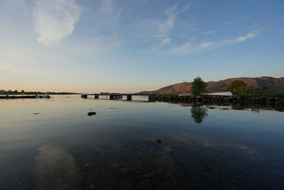 Scenic view of lake against sky during sunset