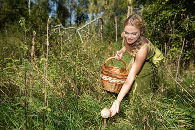 Portrait of young woman picking plants
