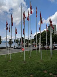 Panoramic shot of flags on field against sky