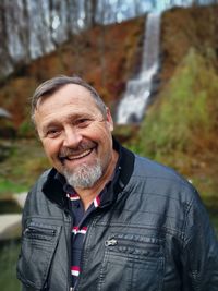 Portrait of smiling man standing outdoors