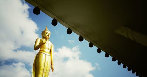 Low angle view of statue against temple against sky