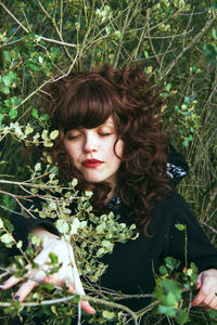 High angle view of woman with eyes closed amidst plants