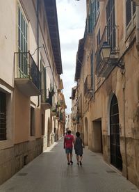 People walking on alley in city