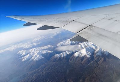 Aerial view of snowcapped mountains against sky