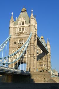 Low angle view of tower bridge against buildings