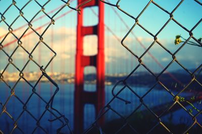 Close-up of chainlink fence against sky