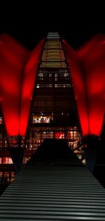 Low angle view of illuminated building against sky at night