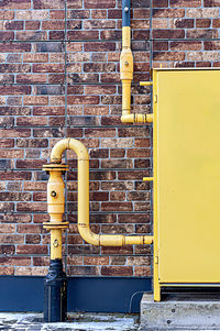 Rusty metal against brick wall