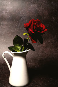 Close-up of red rose flower vase on table