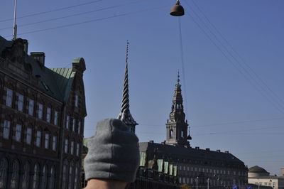 Low angle view of statue against buildings in city
