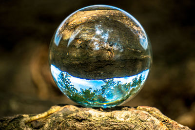 Close-up of crystal ball on rock