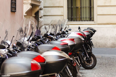 Motor scooter parked on street against building