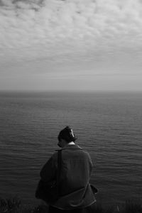 Rear view of man standing at beach