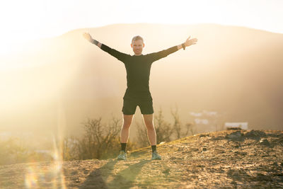 Full length of man standing on mountain against sky