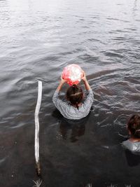 High angle view of woman swimming in lake