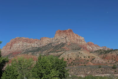 Scenic view of rocky mountains against clear blue sky