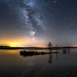 Scenic view of lake against sky at night