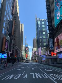 View of city street and buildings against sky