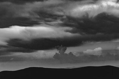 Low angle view of silhouette mountain against sky