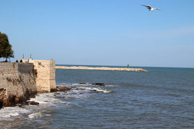 Scenic view of sea against clear blue sky