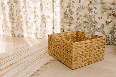 Wicker square basket in the interior of the house