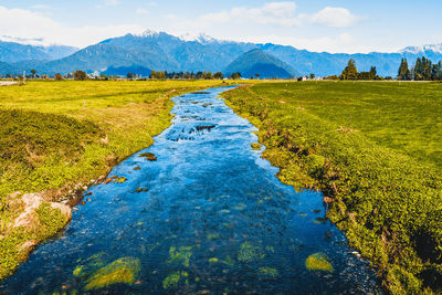 Scenic view of green mountains against sky