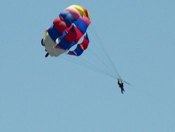 Low angle view of kite flying against clear blue sky