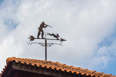 Low angle view of building against cloudy sky