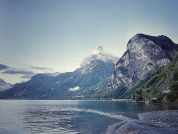 Scenic view of mountains and lake against sky